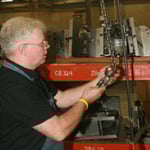 Image of man working on crane inspection