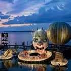Image of Pfaff-silberblau BETA moving the collar of the Rigoletto on the lake stage at the Bregenz Festival