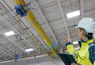Image of Woman in Hard hat looking at Crane System