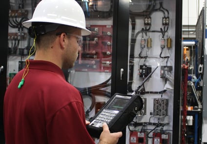 Image of Man in Hardhat and Goggles working on Equipment