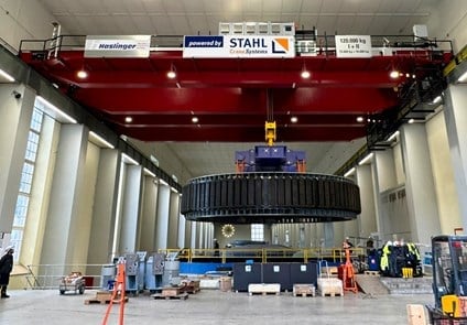 Hydropower plant maintenance work being carried out with heavy industrial equipment.