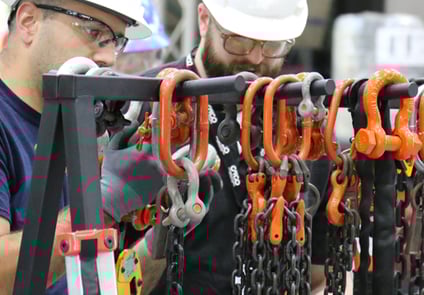 Image of two men working together on chain equipment