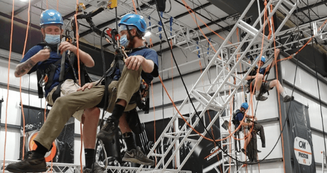 Image of two men on entertainment rigging