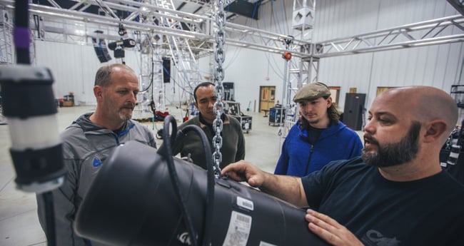 Image of three men conducting a CM-ET Hoist Inspection