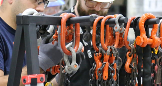 Image of two men working together on chain equipment