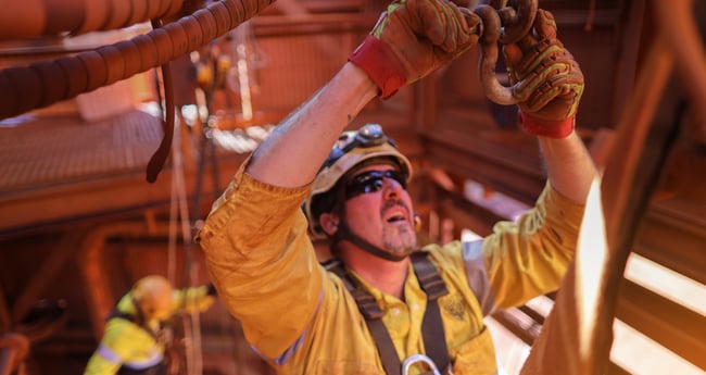 Image of a man with sunglasses and a hardhat on conducting a Shackle Inspection Checklist