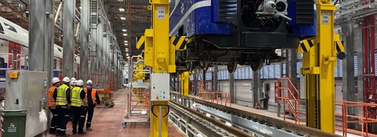 Image of Train Being Lifted By Crane System